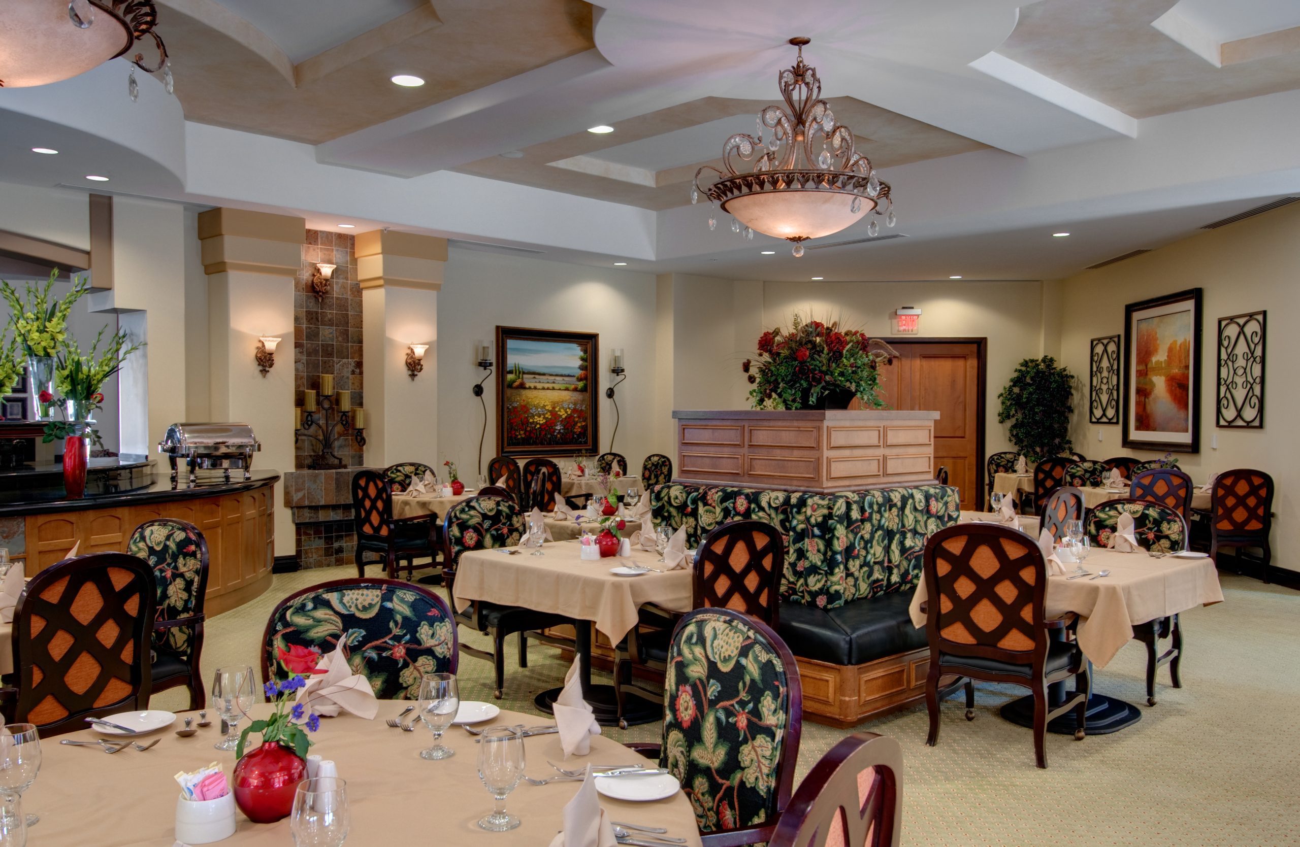 A dining room with neatly arranged tables and chairs, ready to welcome guests and provide a comfortable dining experience.