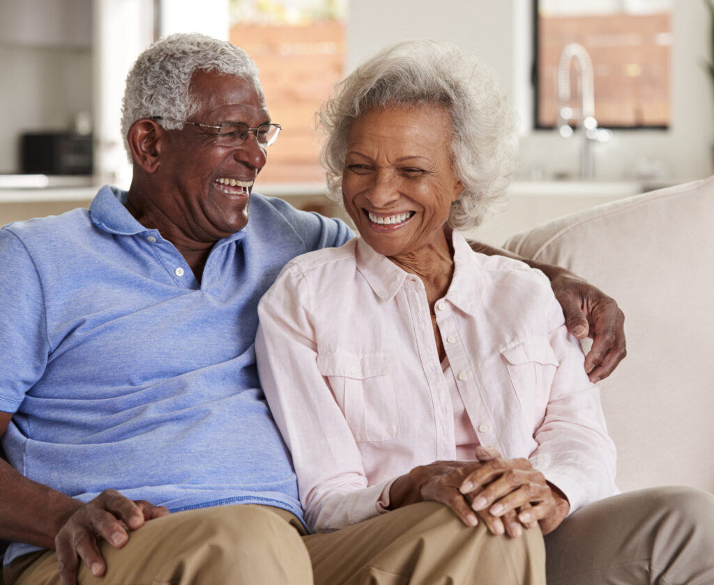 senior couple sitting on couch
