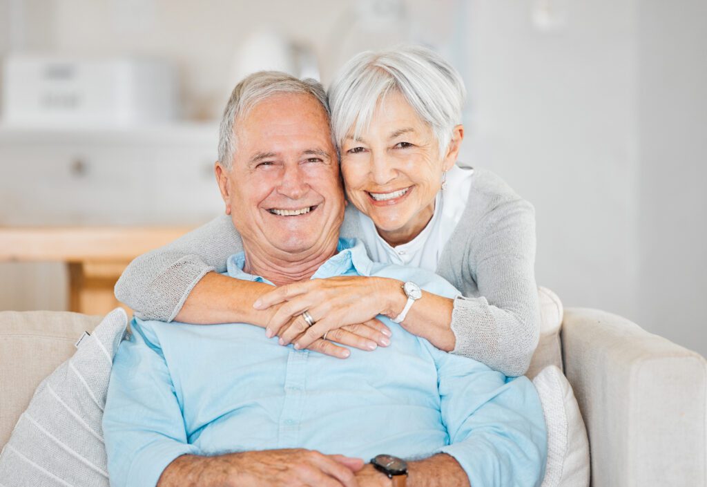 Happy senior couple hugging smiling taking photo
