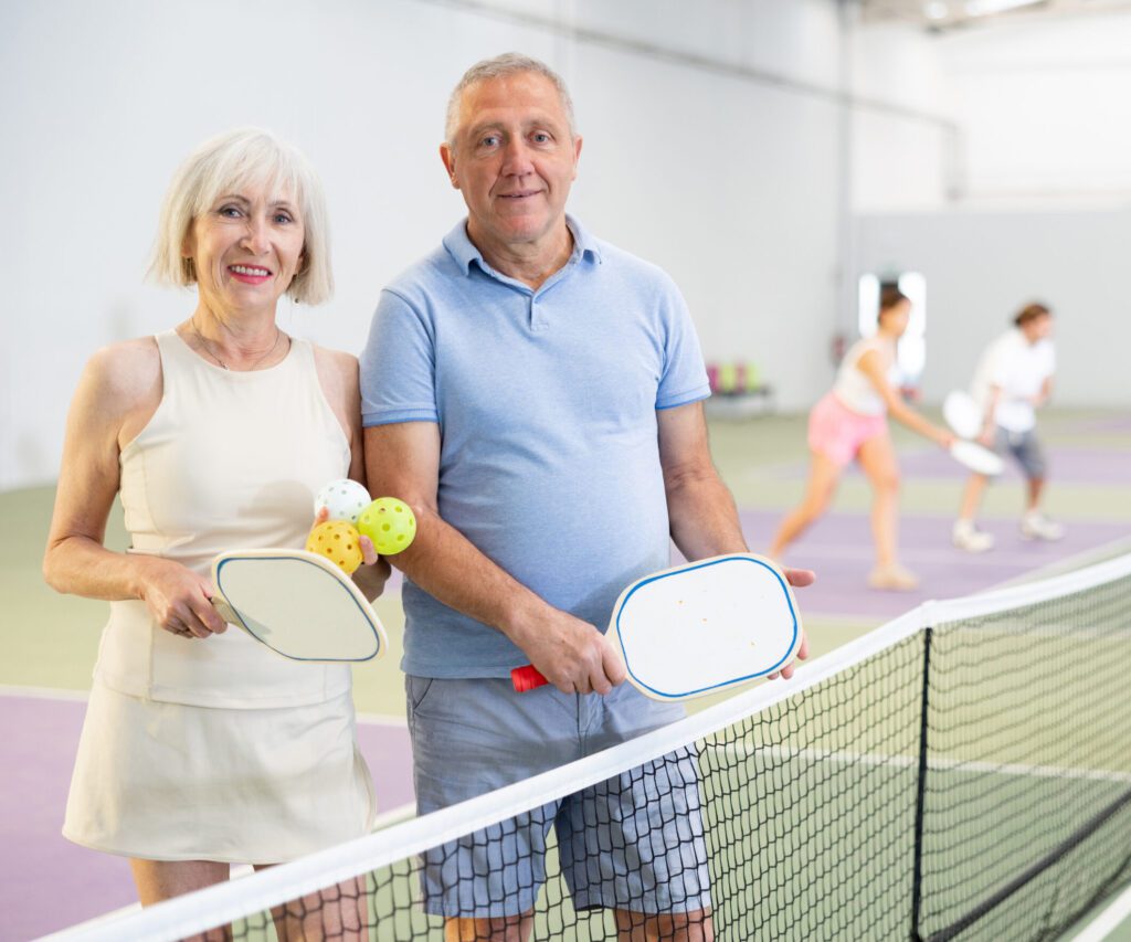 senior couple playing pickleball