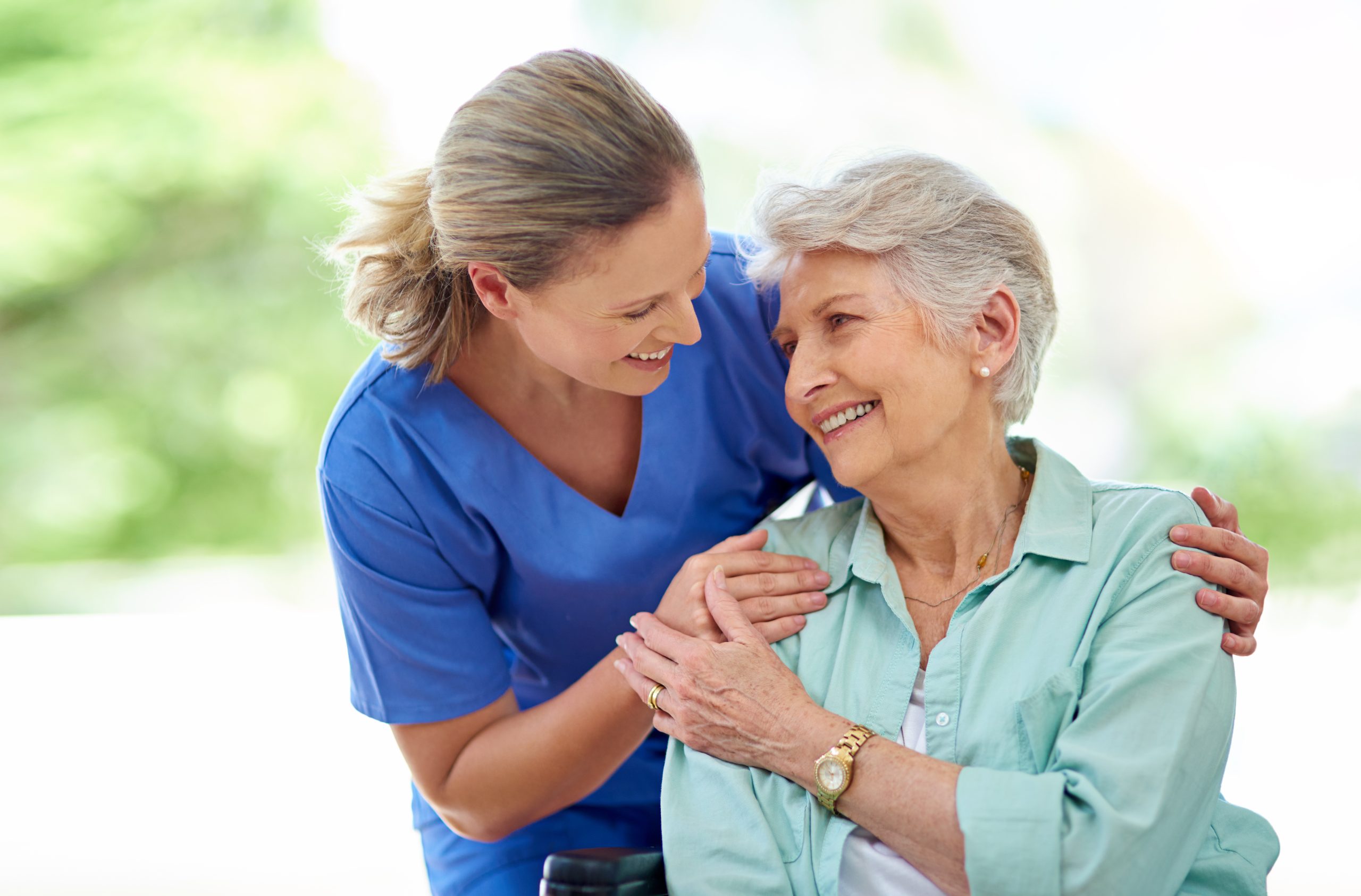 A caring nurse assisting an elderly woman with a gentle touch, providing comfort and support.