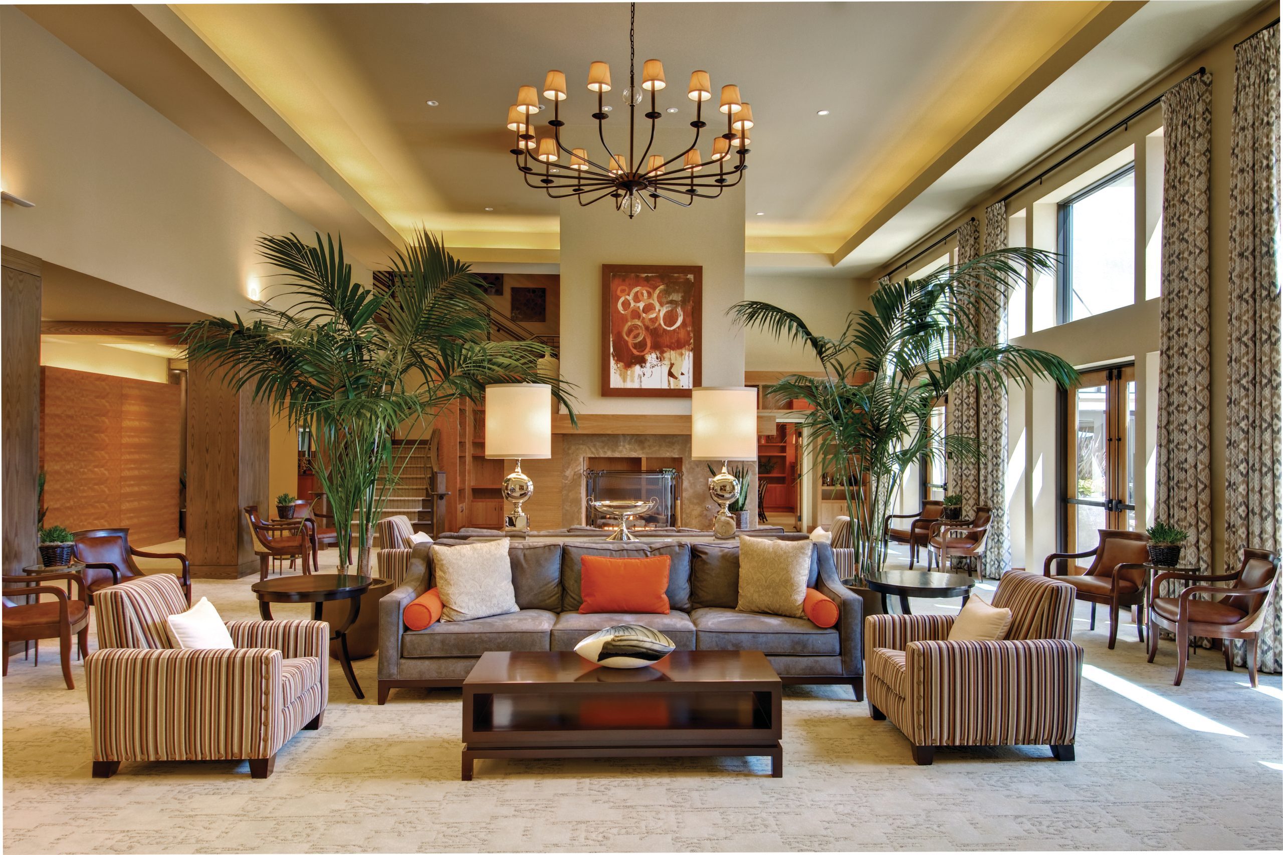 A well-furnished living room with comfortable seating, a stylish coffee table, and an elegant chandelier.