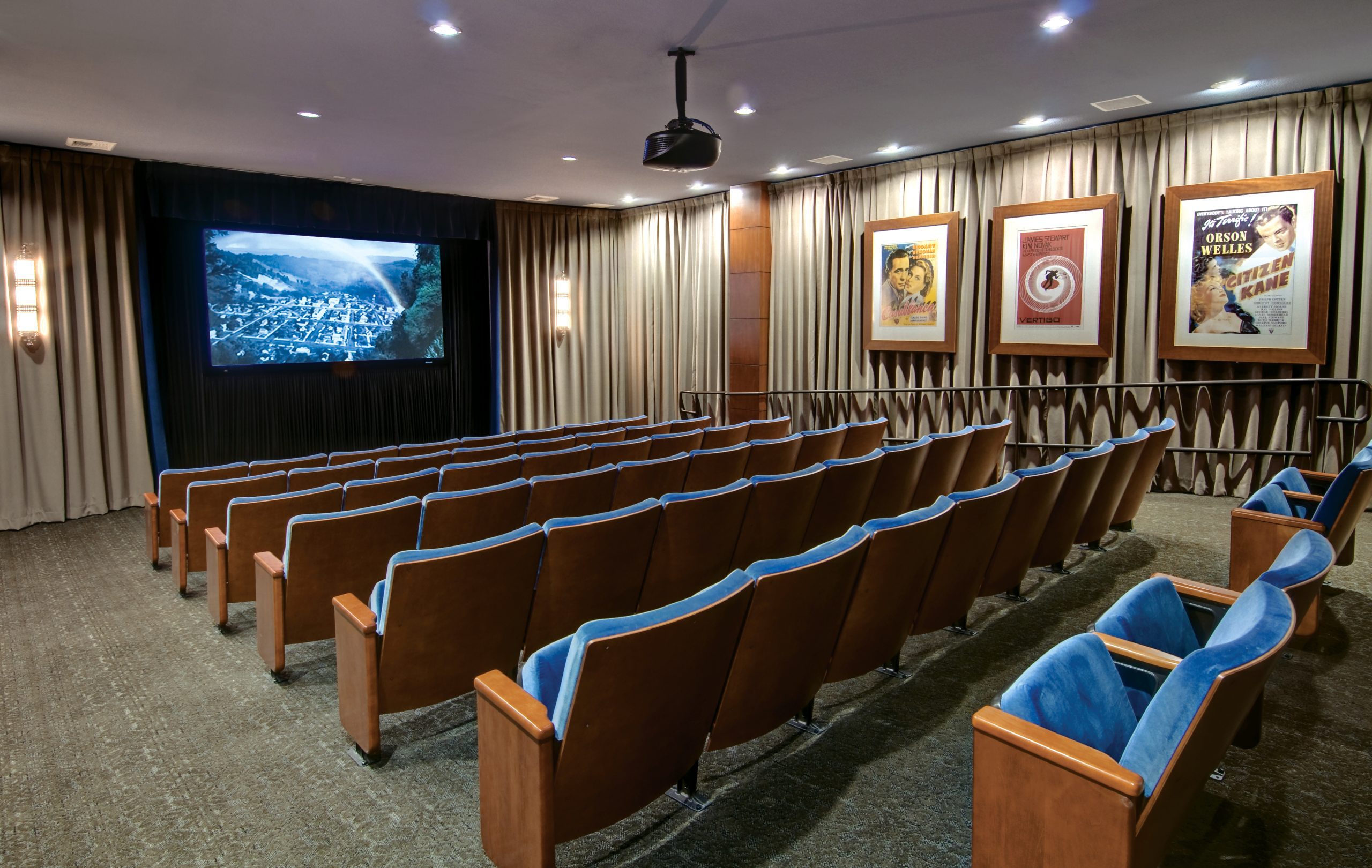 movie theater in a retirement community with blue chairs and 5 rows