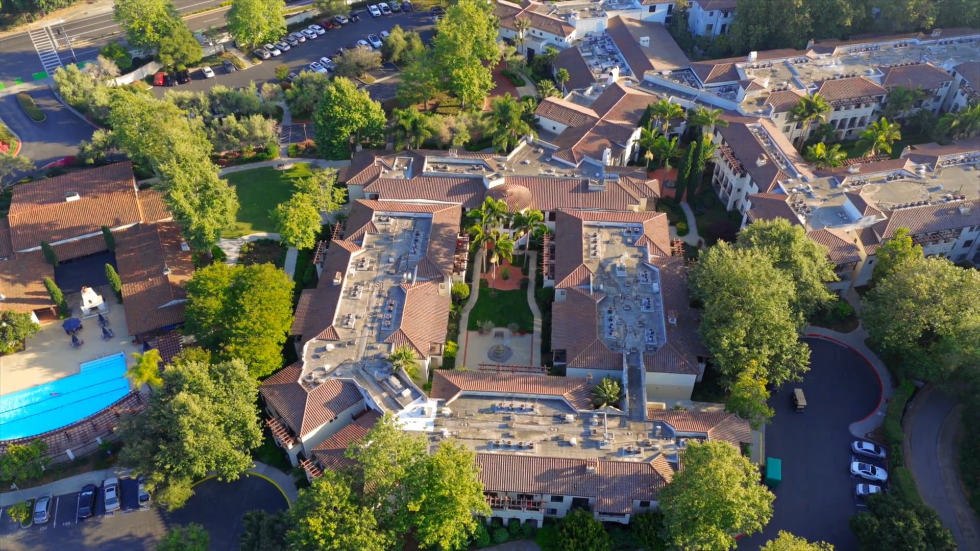 A serene courtyard adorned with palm trees and a beautiful fountain creating a tranquil ambiance 