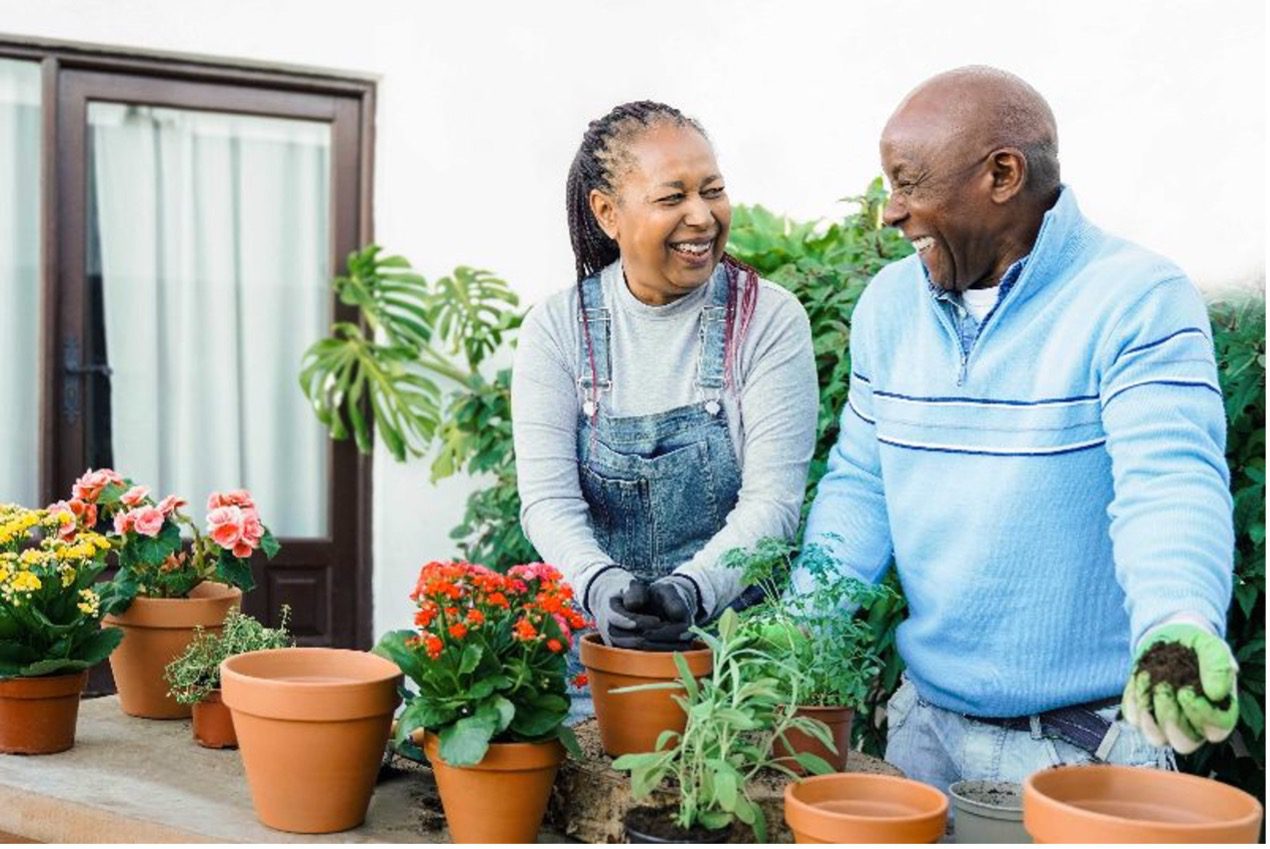 srg-maintain-lifestyle A man and a woman potting flowers together by Senior Resource Group