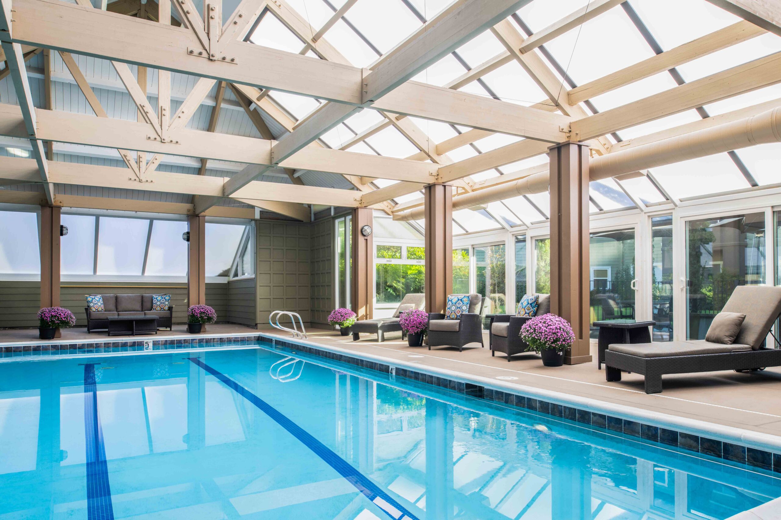 An indoor pool with a roof, providing a serene and sheltered environment for swimming and relaxation.